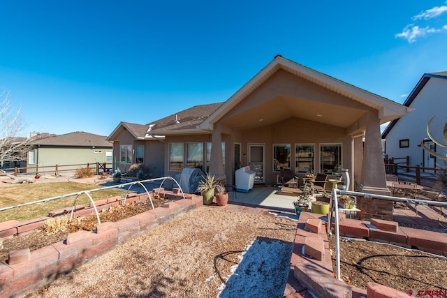 rear view of property featuring a patio area