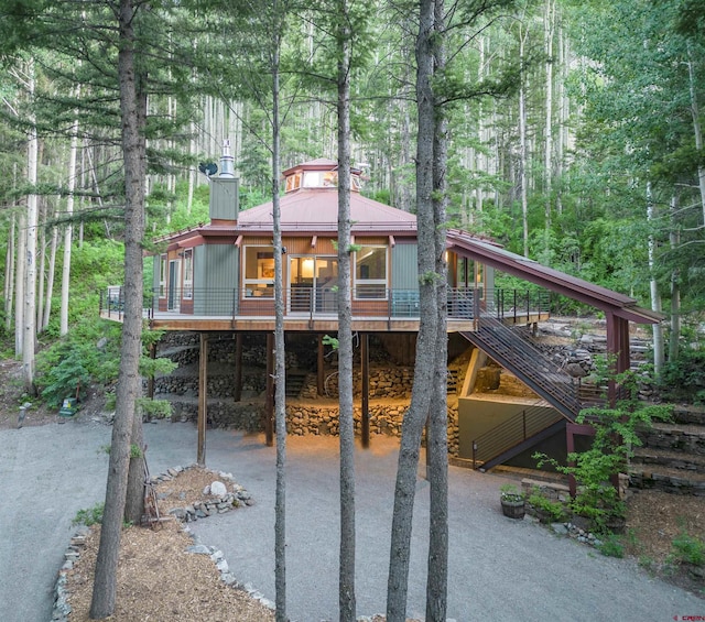 back of property featuring a wooden deck