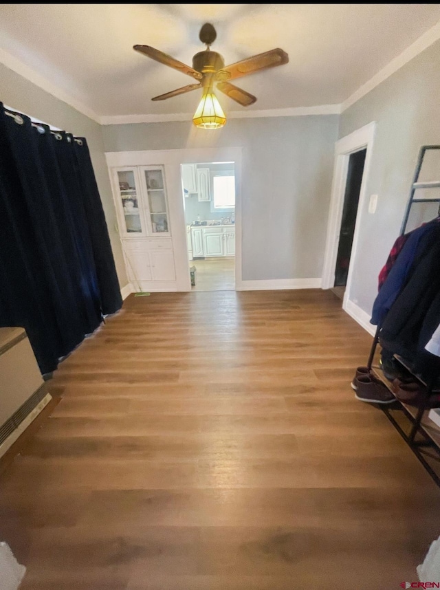 interior space featuring crown molding, ceiling fan, and light hardwood / wood-style flooring