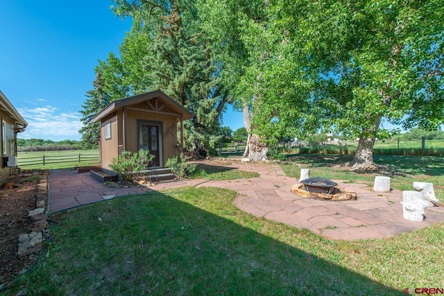 view of yard with an outbuilding and an outdoor fire pit