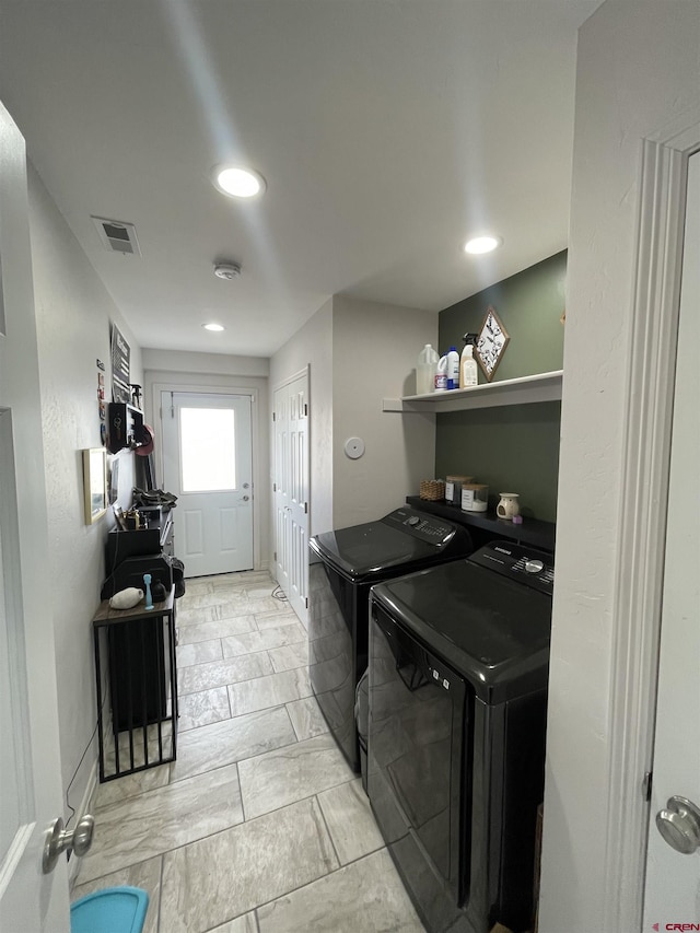 clothes washing area featuring independent washer and dryer