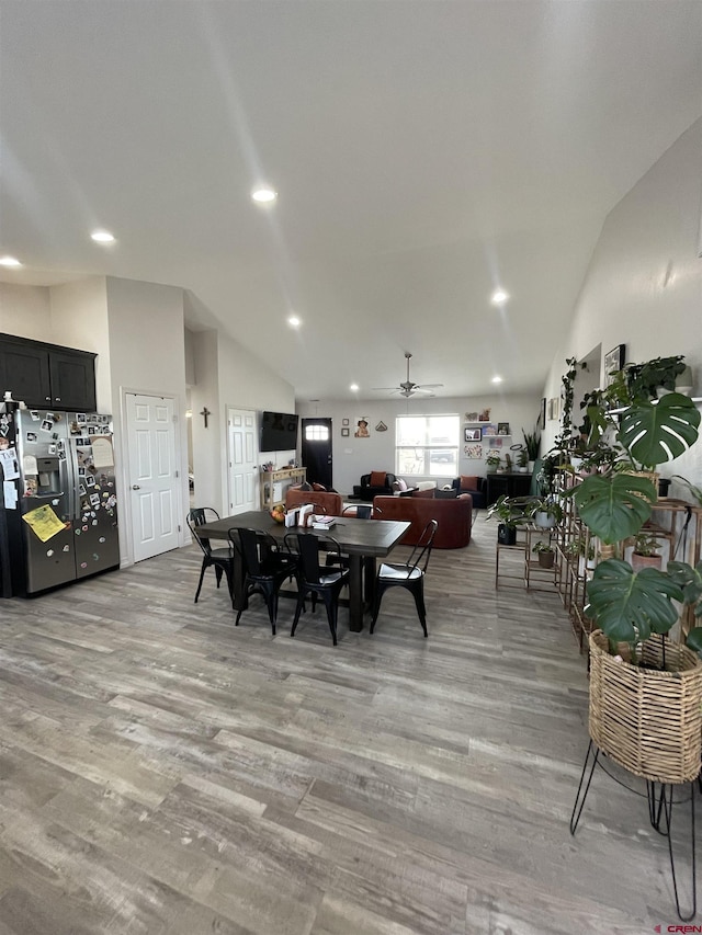 dining space featuring vaulted ceiling, ceiling fan, and light hardwood / wood-style floors