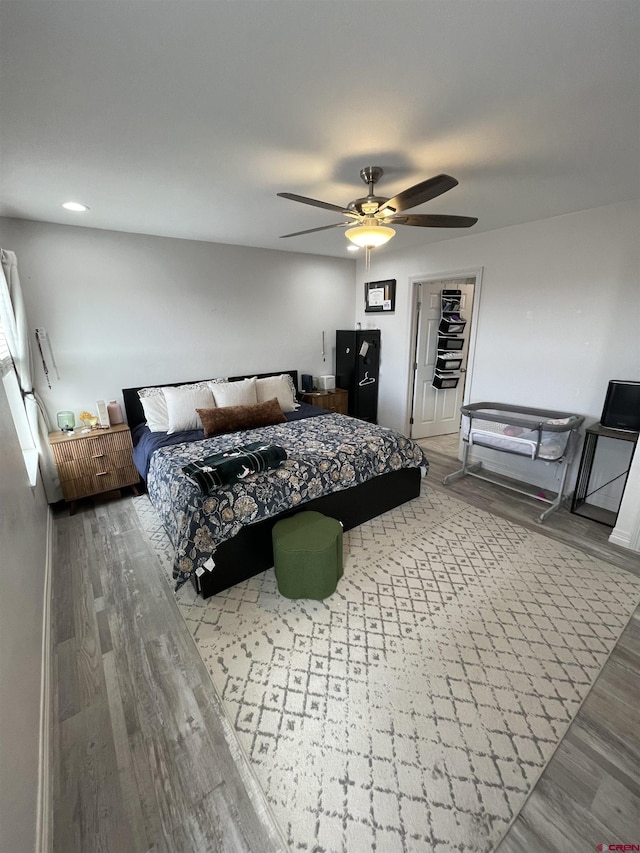 bedroom with hardwood / wood-style flooring and ceiling fan