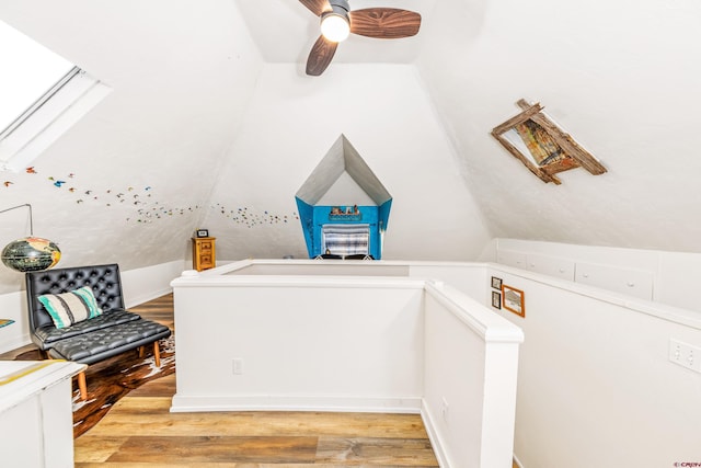 additional living space featuring a ceiling fan, light wood finished floors, and vaulted ceiling