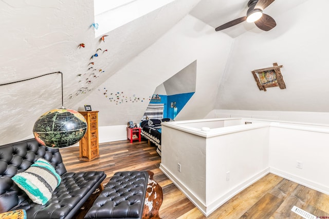 interior space featuring visible vents, lofted ceiling, wood finished floors, and ceiling fan