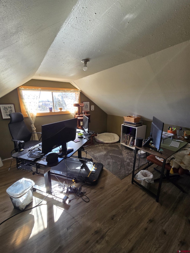 office with vaulted ceiling, hardwood / wood-style floors, and a textured ceiling