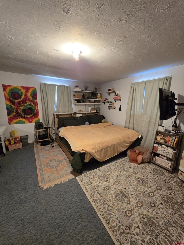 bedroom with carpet floors and a textured ceiling