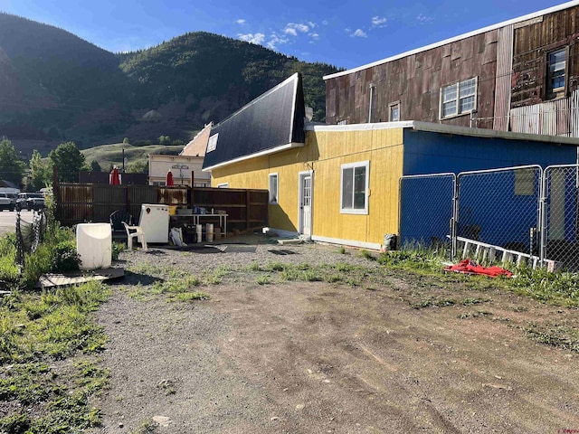 rear view of house featuring a mountain view