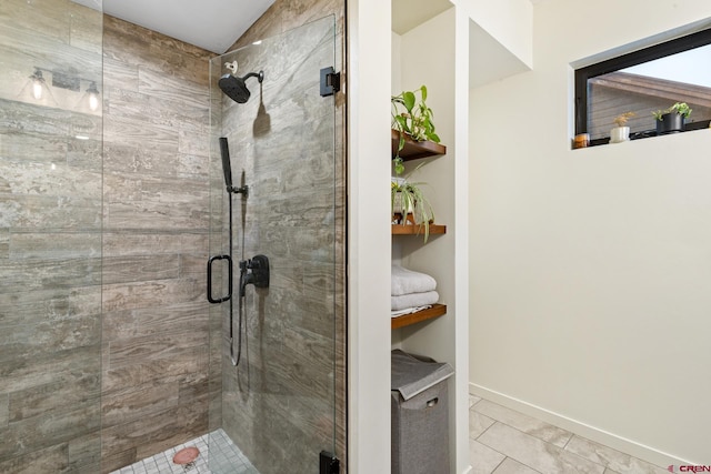 bathroom featuring tile patterned floors and a shower with shower door