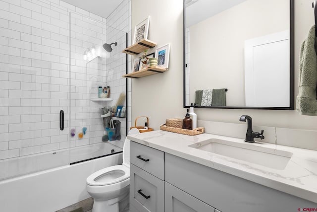 full bathroom featuring bath / shower combo with glass door, vanity, and toilet