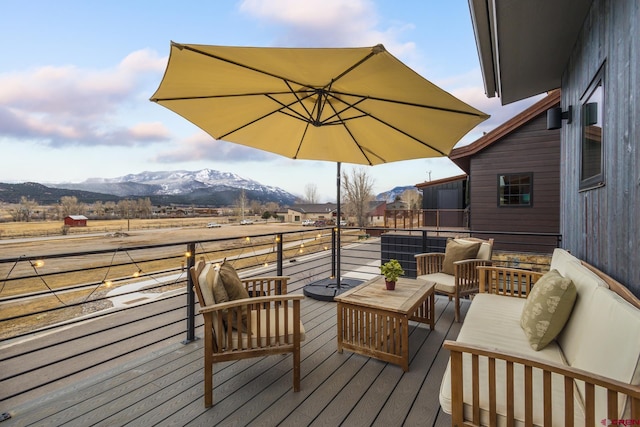 deck featuring outdoor lounge area and a mountain view