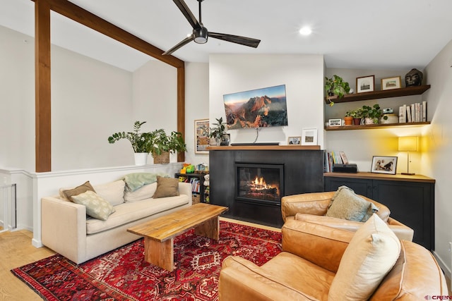 living room with hardwood / wood-style flooring, ceiling fan, and lofted ceiling with beams