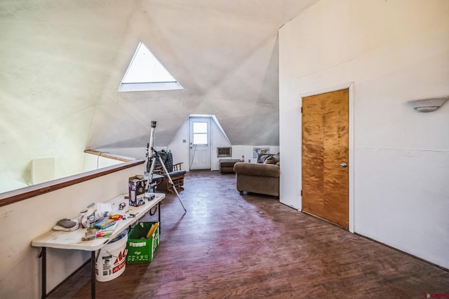 additional living space with dark wood-type flooring and vaulted ceiling