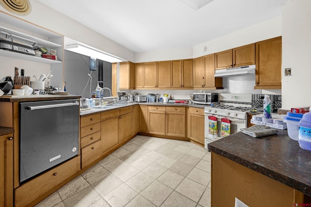 kitchen with sink, stainless steel dishwasher, kitchen peninsula, and gas range gas stove