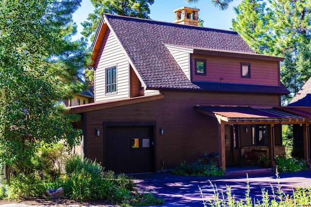 view of front facade featuring a garage and covered porch