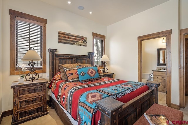 carpeted bedroom with connected bathroom