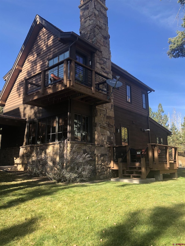 rear view of house featuring a yard