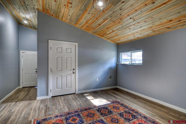 empty room featuring lofted ceiling, hardwood / wood-style floors, and wood ceiling