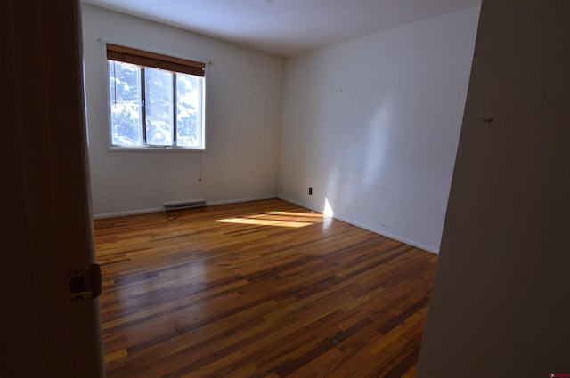 empty room with dark wood-type flooring