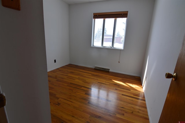 empty room with dark wood-type flooring