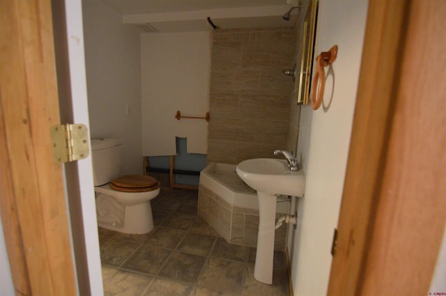 bathroom with tiled shower and toilet