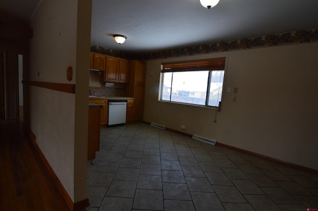 kitchen with backsplash, light tile patterned floors, stainless steel dishwasher, and sink