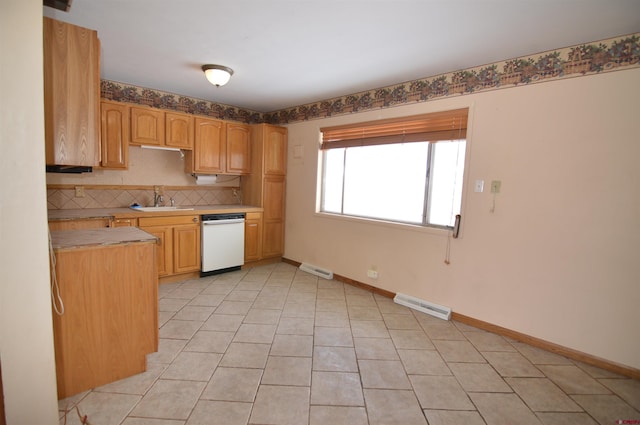 kitchen featuring light brown cabinetry, sink, backsplash, light tile patterned floors, and white dishwasher