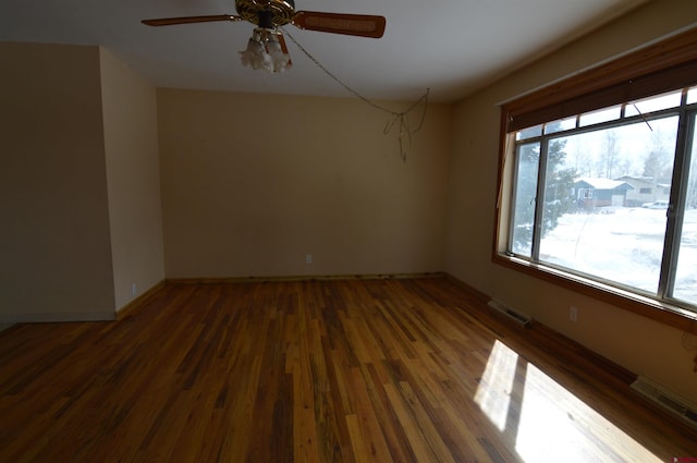 unfurnished room with ceiling fan and dark hardwood / wood-style floors