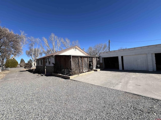 view of side of property featuring a garage and an outbuilding