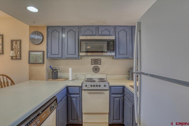 kitchen featuring white appliances and kitchen peninsula