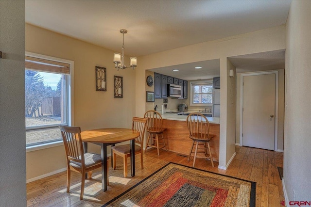 dining room with an inviting chandelier and light wood-type flooring