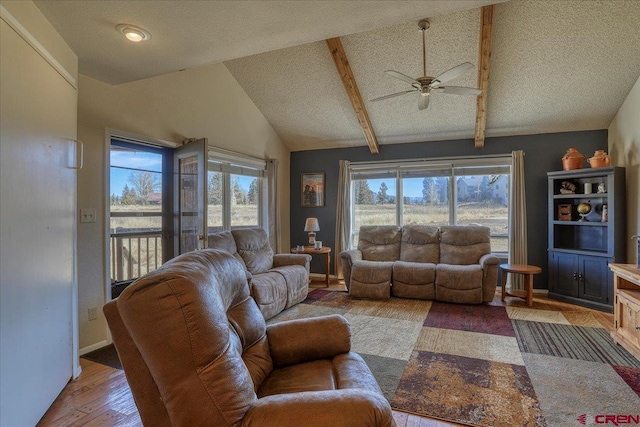 living room with vaulted ceiling with beams, a textured ceiling, wood-type flooring, and ceiling fan