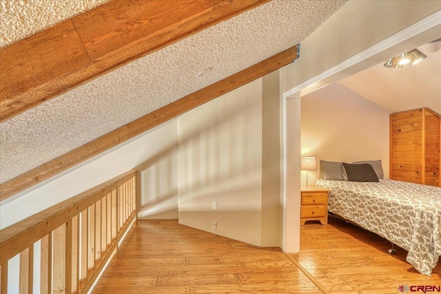 bedroom with lofted ceiling and light hardwood / wood-style floors