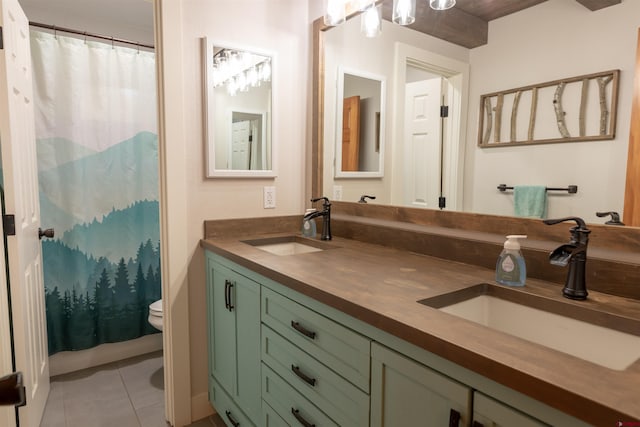 bathroom with toilet, tile patterned flooring, vanity, and walk in shower