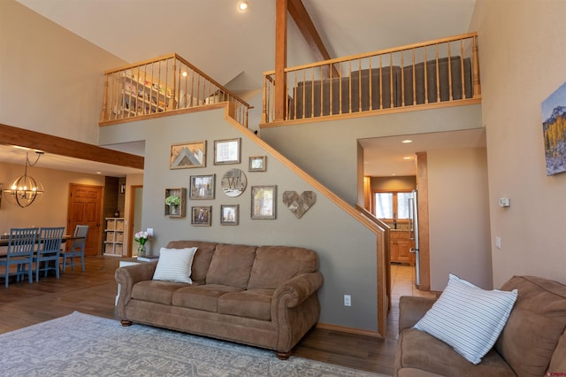 living room featuring high vaulted ceiling, an inviting chandelier, and wood-type flooring