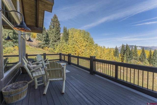 wooden deck with a mountain view