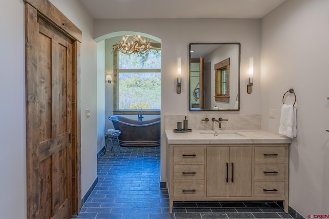 bathroom featuring tasteful backsplash, vanity, and a bathing tub