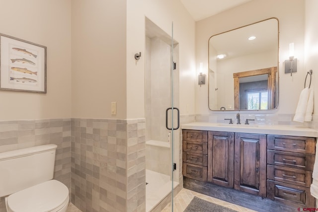 bathroom featuring tile walls, vanity, toilet, and walk in shower