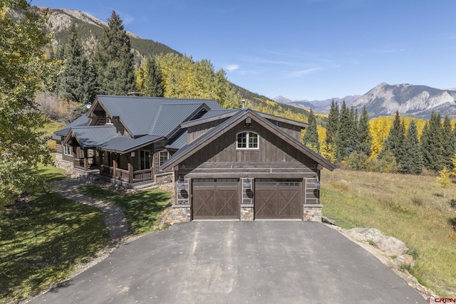 view of front of property with a mountain view, a garage, and covered porch