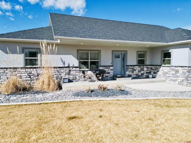 rear view of property featuring a lawn