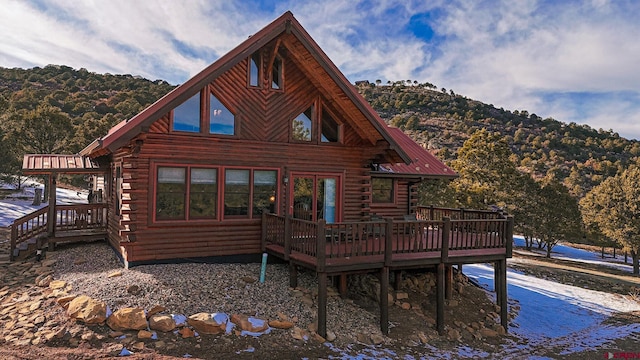 back of property with a wooden deck