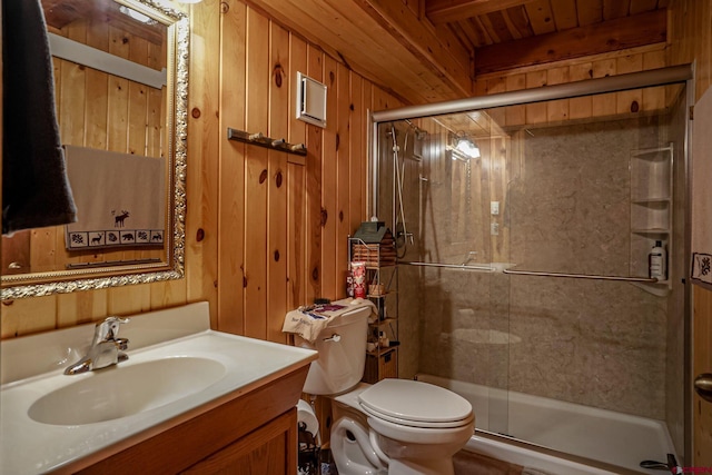 bathroom featuring toilet, vanity, wood walls, and walk in shower