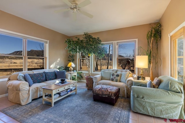 tiled living room with ceiling fan