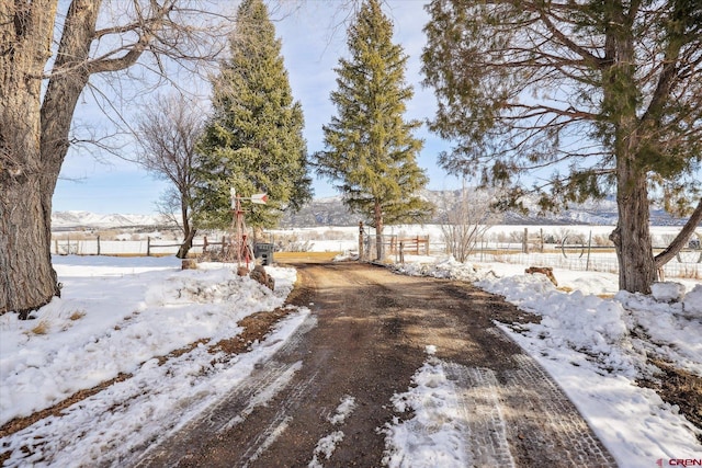 snowy yard with a mountain view