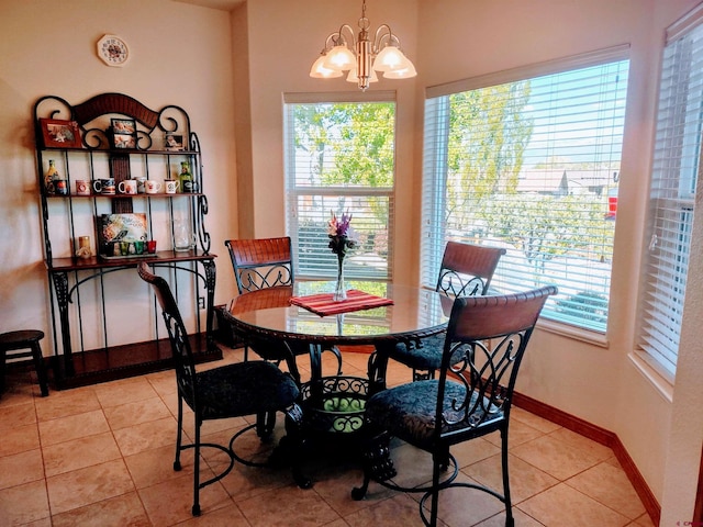 tiled dining area with an inviting chandelier and plenty of natural light