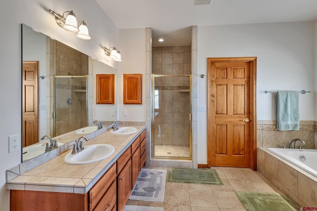 bathroom with vanity, tile patterned flooring, and shower with separate bathtub