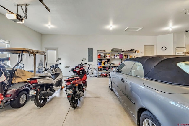 garage with a garage door opener and electric panel