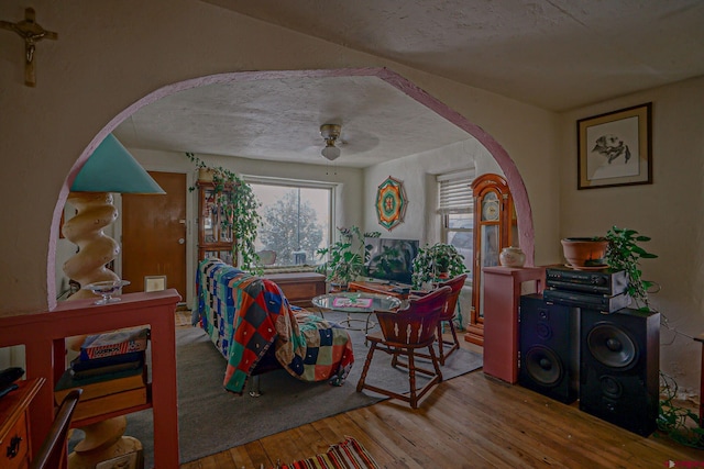 dining space featuring hardwood / wood-style flooring, ceiling fan, and a textured ceiling