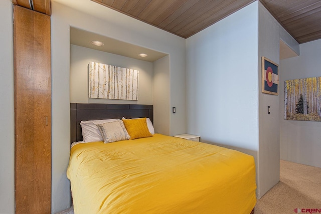 carpeted bedroom with wood ceiling