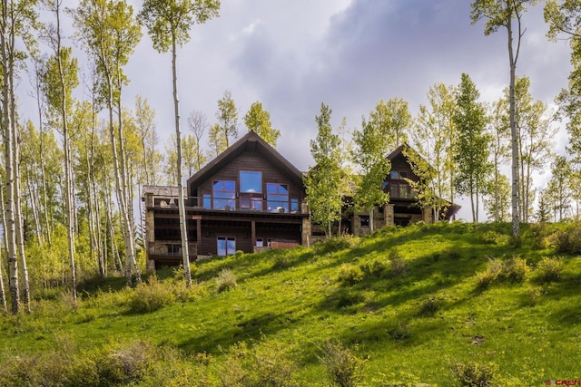 rear view of property with a deck and a yard